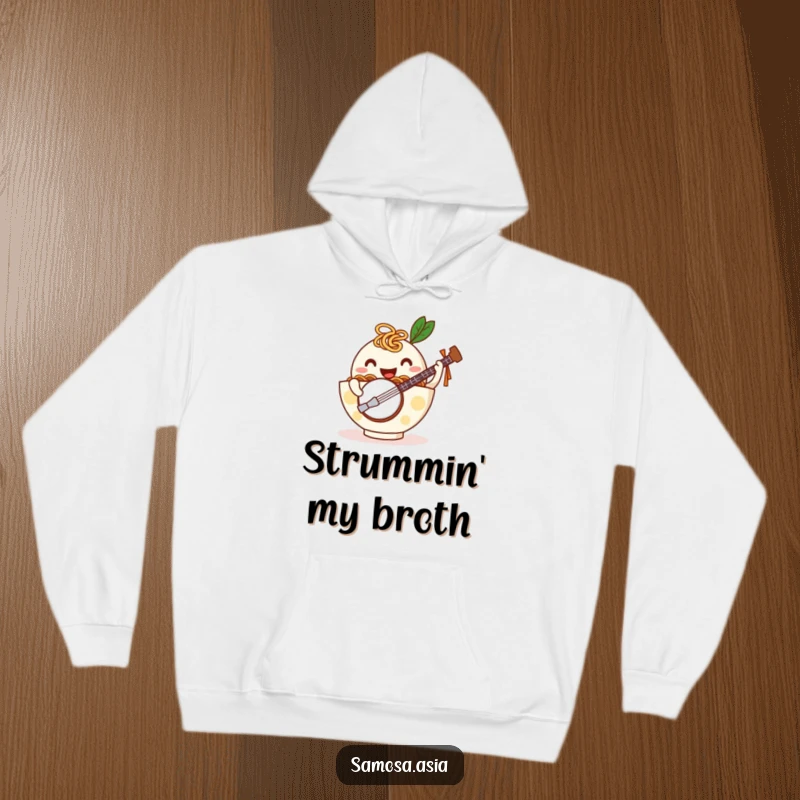Funny hoodie featuring a happy ramen bowl with noodle arms playing a tiny banjo, offering cozy comfort and humorous musical vibes.